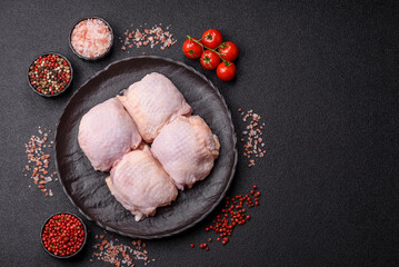 Meat, raw chicken thigh, leg in skin with salt and spices. Raw chicken thigh
