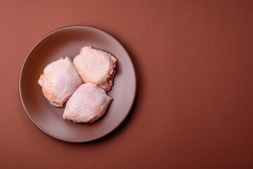Meat, raw chicken thigh, leg in skin with salt and spices. Raw chicken thigh