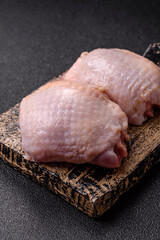 Meat, raw chicken thigh, leg in skin with salt and spices. Raw chicken thigh