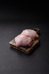 Meat, raw chicken thigh, leg in skin with salt and spices. Raw chicken thigh