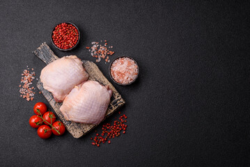 Meat, raw chicken thigh, leg in skin with salt and spices. Raw chicken thigh