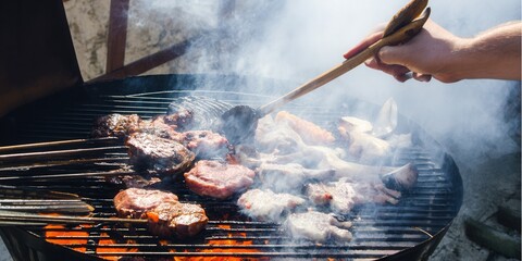Meat sizzling on the grill, ready for a summer barbecue gathering with friends and family.