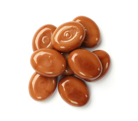 Tasty sweet caramel candies isolated on white, top view