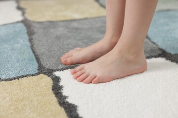 Girl on soft carpet at home, closeup