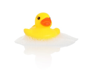 One cute rubber duck and foam on mirror surface against white background