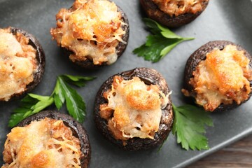 Delicious stuffed mushrooms with parsley on table, top view
