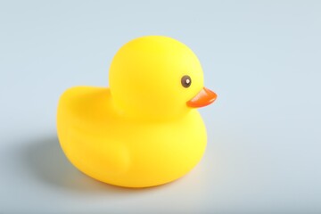 One cute rubber duck on white background, closeup. Space for text