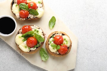 Tasty stuffed mushrooms served on light table, top view. Space for text