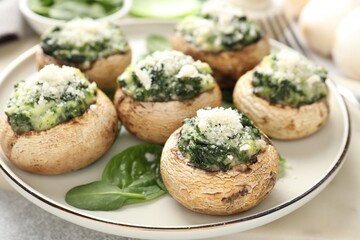 Tasty stuffed mushrooms served on light table, closeup