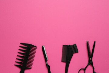 Different hairdresser's tools on pink background, flat lay. Space for text