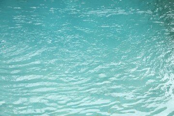 Clear water with ripples in outdoor swimming pool