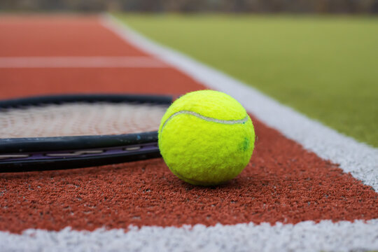 Tennis Ball Lying on Court Surface