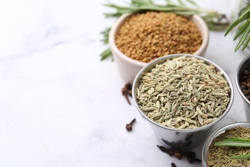 Different aromatic spices on white table, closeup. Space for text