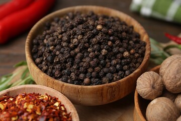 Different aromatic spices on wooden table, closeup