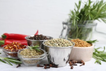Different aromatic spices on white table, closeup