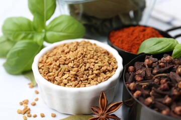 Different aromatic spices on white table, closeup