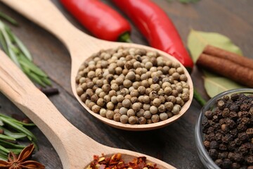 Different aromatic spices on wooden table, closeup