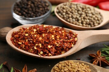 Different aromatic spices on wooden table, closeup