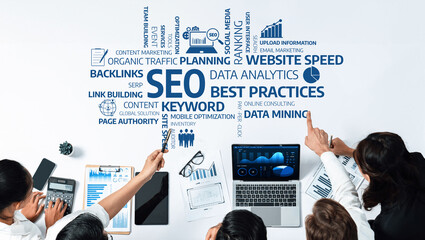 A diverse business team collaborates on digital marketing strategies, focusing on SEO and data...