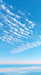 Pale Blue Sky with Vague Cloud Texture over Calm Ocean