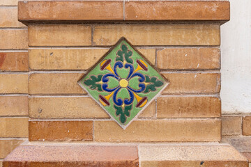 Casco Antiguo, Seville, Andalusia, Spain. Colorful traditional tile decorating an old Spanish building.