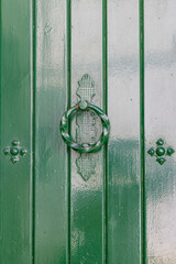 Arcos de la Frontera, Seville Province, Andalusia, Spain. A ring shaped knocker on a green painted...