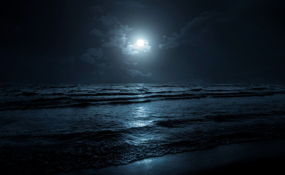 Moon over sea or ocean. Night view. A good background for the theme of travel, vacation, voyage. Moonlight background.