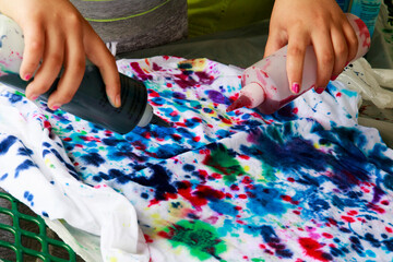 Dye applied for tie-dying on white tee-shirt.