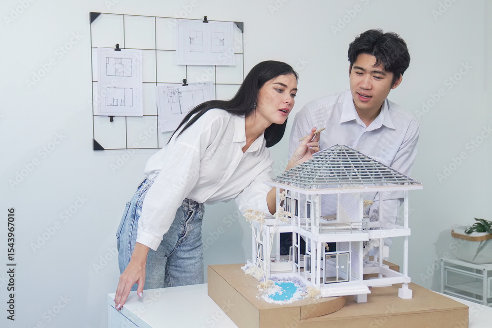 Poster portrait of cooperative engineer team working together to measure house model by using ruler and arc