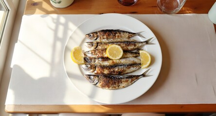 Grilled sardines served on white plate with lemon slices in natural sunlight. Traditional seafood dish, ideal for Mediterranean cuisine, lunch, healthy eating, and food photography themes.