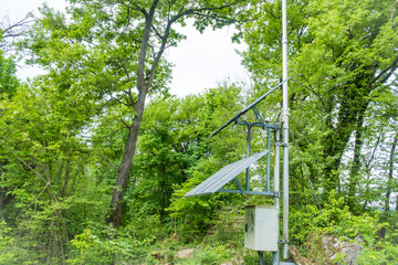 Several solar panels on top of a mountain in the city of Caslano in Switzerland.