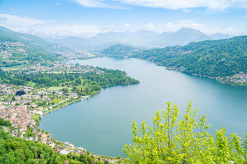 Spring view of Lake Lugano in the town of Caslano in the Swiss mountains