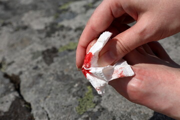 Small foot injury. Bloody paper. Close up and isolated.