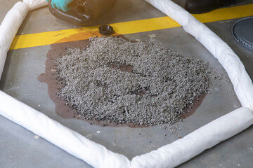 Industrial Spill Containment with Absorbent Booms and Liquid © Savelight Studio