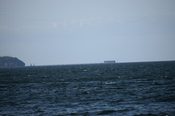 in the photo the sea in the background the shore with buildings