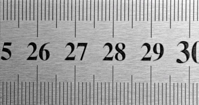 Metal Ruler Close-Up. Video featuring a detailed view of a sleek metal ruler with precise millimeter markings, captured in high clarity.

