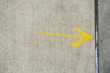 Yellow arrow spray painted on pavement, USA