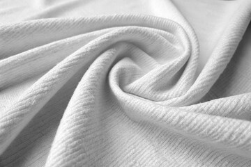 A soft white fabric texture background featuring subtle folds and a delicate weave, perfect for showcasing comfort, purity, and textile quality in various design applications.