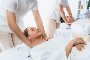 Caucasian couple customer enjoying relaxing anti-stress spa massage and pampering with beauty skin...