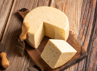 Minas Cheese, Delicious semi-cured cheese from Minas Gerais, Brazil, on rustic wood, selective focus.