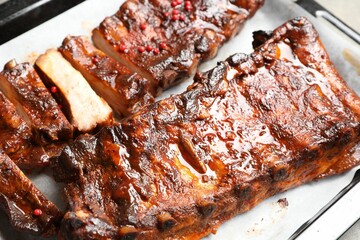 Delicious spare ribs on baking tray, closeup