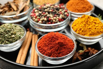 Different aromatic spices on light grey table, closeup