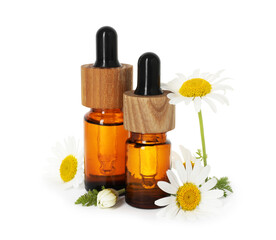 Bottles of essential oil and chamomile flowers isolated on white