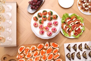 Buffet menu. Many different appetizers on wooden table, flat lay