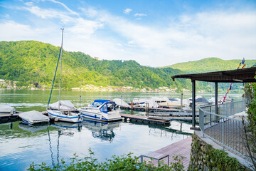 View of boats moored on Lake Lugano, village of Caslano. Switzerland