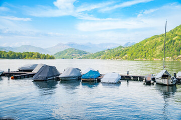 View of boats moored on Lake Lugano, village of Caslano. Switzerland