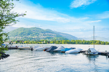 View of boats moored on Lake Lugano, village of Caslano. Switzerland