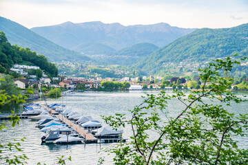 View of boats moored on Lake Lugano, village of Caslano. Switzerland