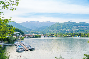 View of boats moored on Lake Lugano, village of Caslano. Switzerland