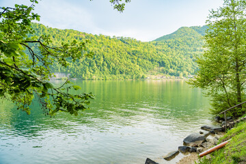 Spring view of Lake Lugano in the town of Caslano in the Swiss mountains